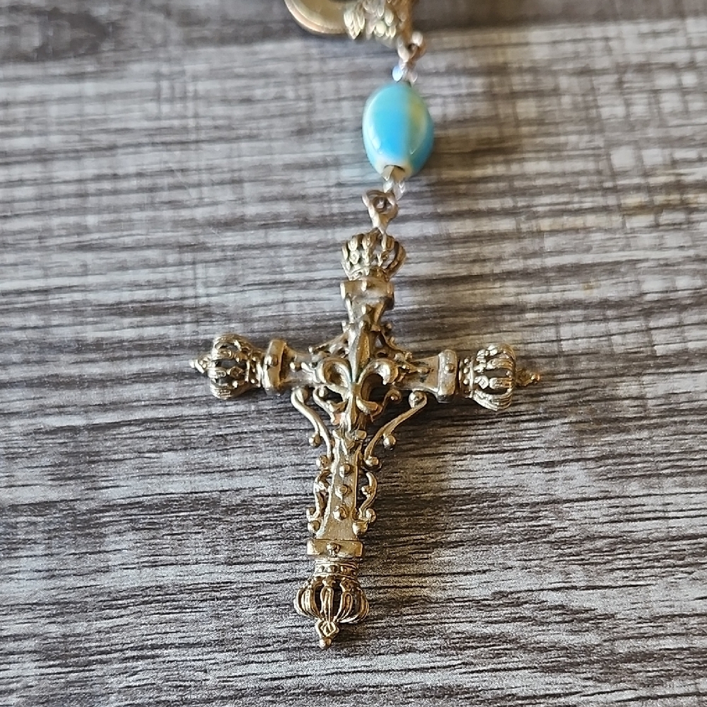 Ornate Gold Cross Pendant with Blue Bead